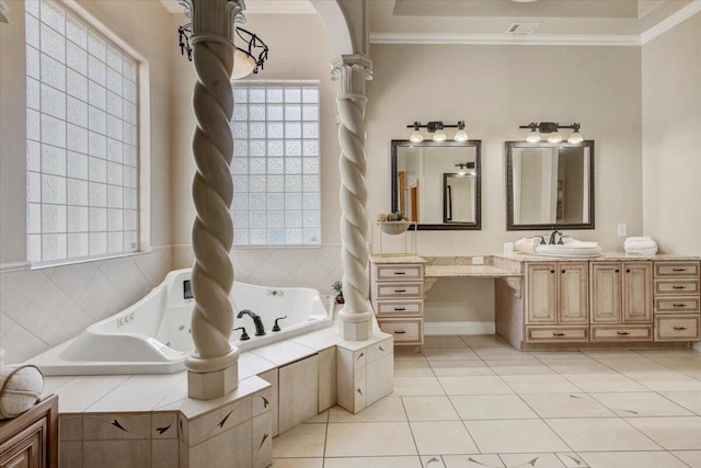 bathroom with vanity, tile patterned flooring, crown molding, and tiled tub