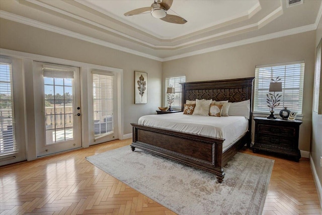 bedroom with multiple windows, access to outside, ornamental molding, ceiling fan, and a tray ceiling