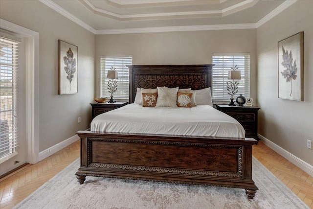 bedroom featuring multiple windows, a tray ceiling, and ornamental molding