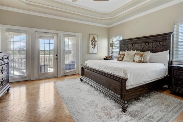 bedroom featuring access to exterior, a raised ceiling, ornamental molding, and light parquet flooring