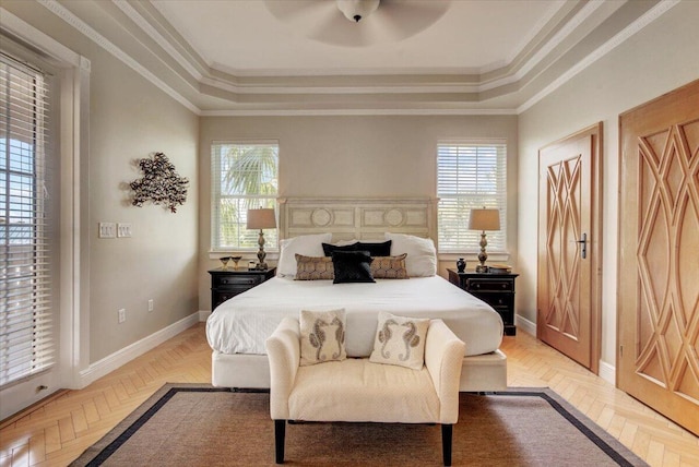 bedroom featuring ceiling fan, light parquet floors, a tray ceiling, and ornamental molding