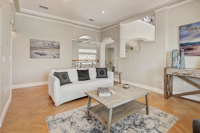 living room with crown molding, light parquet flooring, and decorative columns