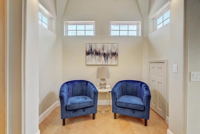 living area with vaulted ceiling and parquet flooring