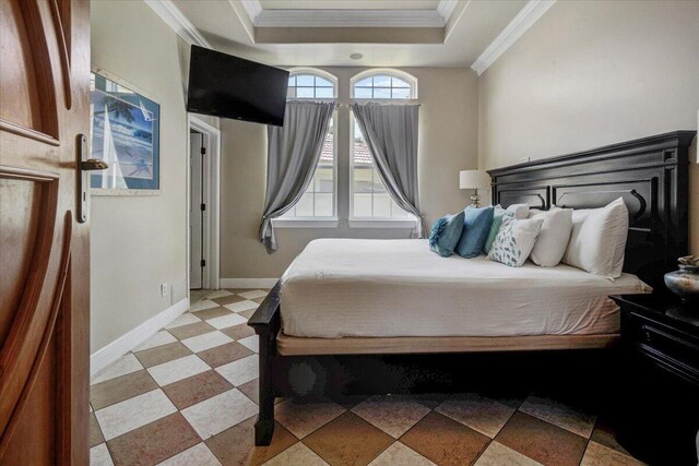 bedroom featuring crown molding and a tray ceiling