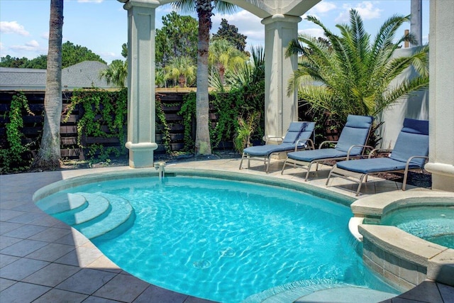 view of pool featuring an in ground hot tub