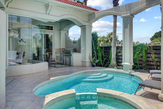 view of swimming pool with grilling area, a patio area, area for grilling, and an in ground hot tub