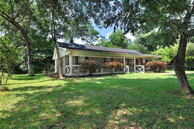 view of front of property with a front lawn and brick siding