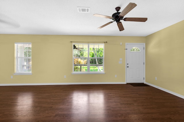 entryway with dark wood-style floors, visible vents, baseboards, and a ceiling fan