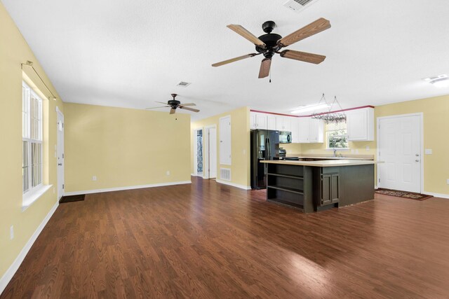 kitchen featuring dark wood-style flooring, visible vents, white cabinets, a center island, and black refrigerator with ice dispenser