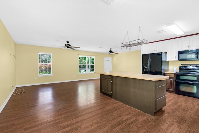 kitchen featuring dark wood finished floors, a kitchen island, open floor plan, light countertops, and black appliances