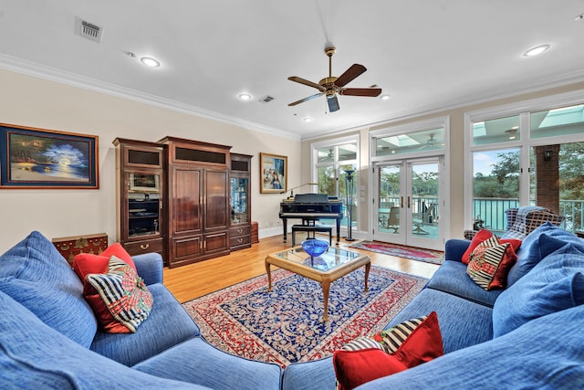 living room with french doors, ceiling fan, light wood-type flooring, and ornamental molding