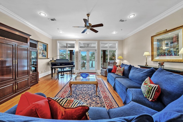 living room featuring french doors, light hardwood / wood-style floors, crown molding, and ceiling fan