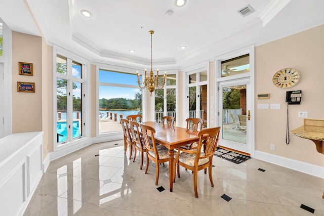 tiled dining room featuring crown molding, a water view, a notable chandelier, and a tray ceiling