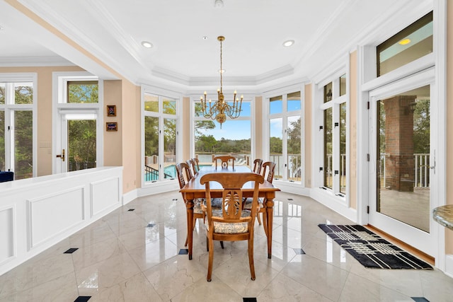 sunroom / solarium featuring an inviting chandelier and a raised ceiling