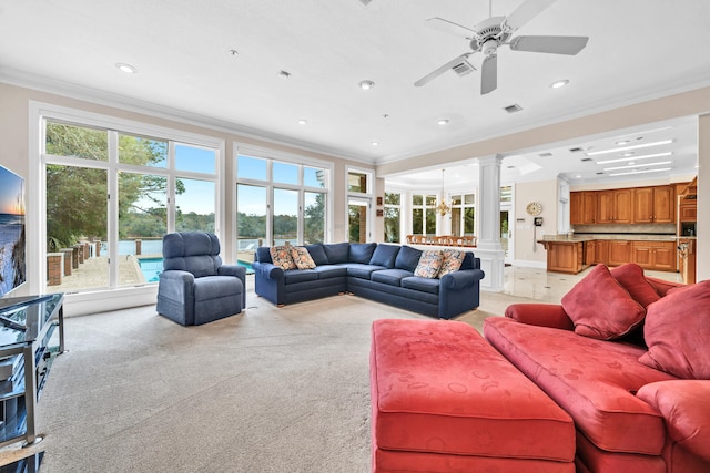 living room with crown molding, light carpet, ornate columns, and ceiling fan