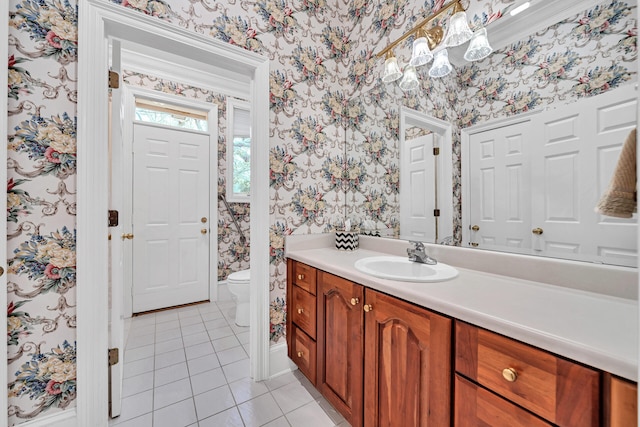 bathroom with tile flooring, vanity, and toilet