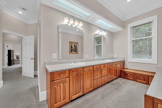 bathroom featuring dual sinks, crown molding, and large vanity