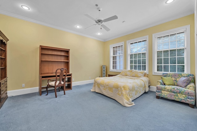 carpeted bedroom featuring ceiling fan and crown molding