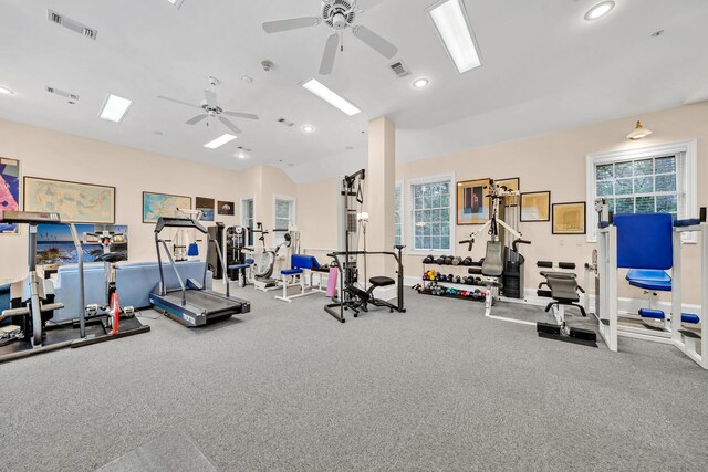 exercise room featuring ceiling fan, carpet floors, and lofted ceiling