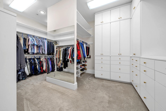 walk in closet featuring light carpet