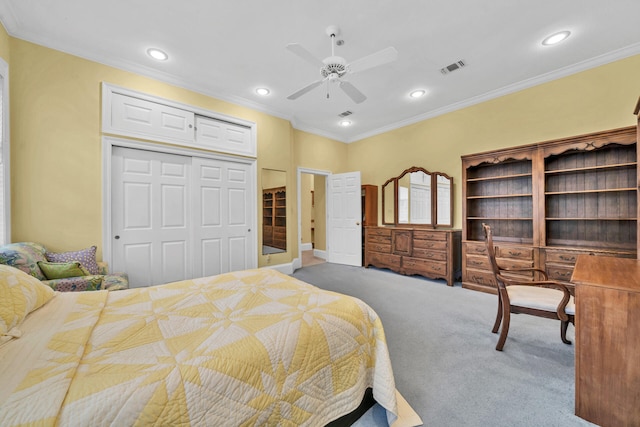 carpeted bedroom featuring ornamental molding, ceiling fan, and a closet