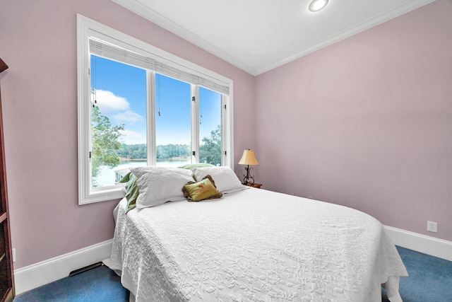 bedroom featuring dark colored carpet and crown molding