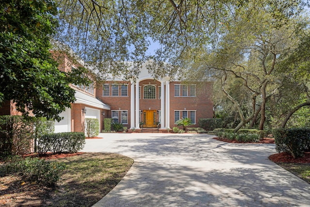 neoclassical home featuring a garage