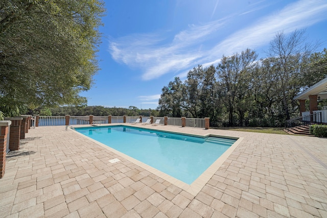 view of swimming pool featuring a patio area