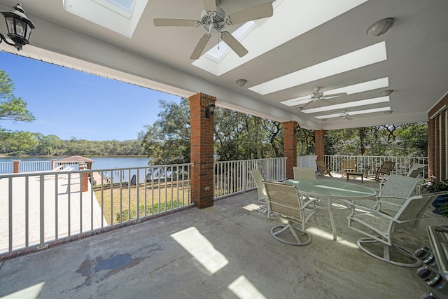 view of patio / terrace with ceiling fan and a water view