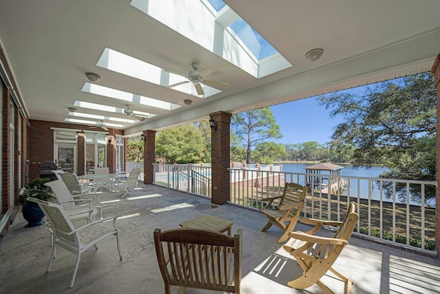 view of terrace featuring a water view and ceiling fan