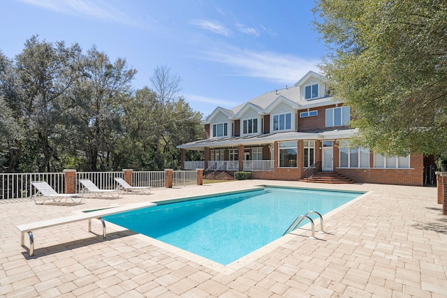 view of swimming pool with a patio, a diving board, and central air condition unit