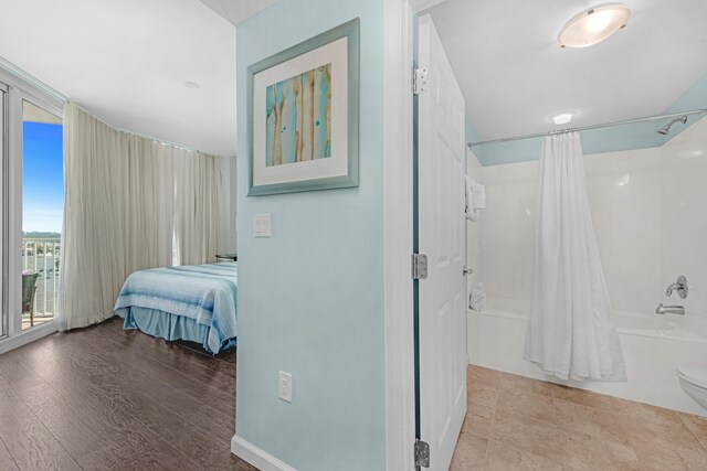 4203 Indian Bayou Trl Unit 1712, Destin, FL 32541 - bedroom with access to exterior and wood finished floors