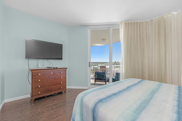 bedroom featuring access to exterior and dark hardwood / wood-style flooring