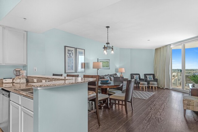 4203 Indian Bayou Trl Unit 1712, Destin, FL 32541 - kitchen with dark wood finished floors, dishwasher, white cabinetry, light stone countertops, and a wall of windows
