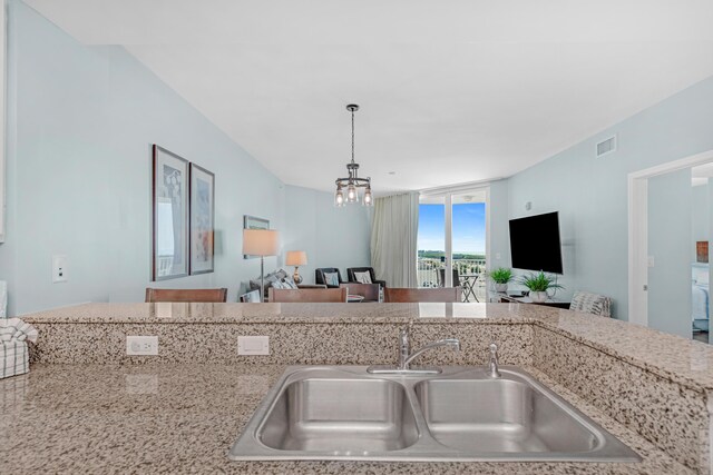 4203 Indian Bayou Trl Unit 1712, Destin, FL 32541 - kitchen with a sink, open floor plan, decorative light fixtures, and a chandelier