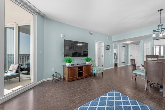 4203 Indian Bayou Trl Unit 1712, Destin, FL 32541 - living room featuring wood finished floors, baseboards, and a chandelier