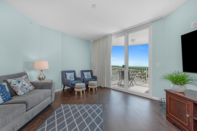 4203 Indian Bayou Trl Unit 1712, Destin, FL 32541 - living room with a wall of windows, dark wood-style floors, and baseboards