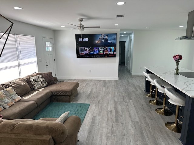 living room with hardwood / wood-style floors and ceiling fan