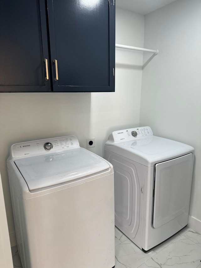 laundry room with cabinets and washing machine and clothes dryer