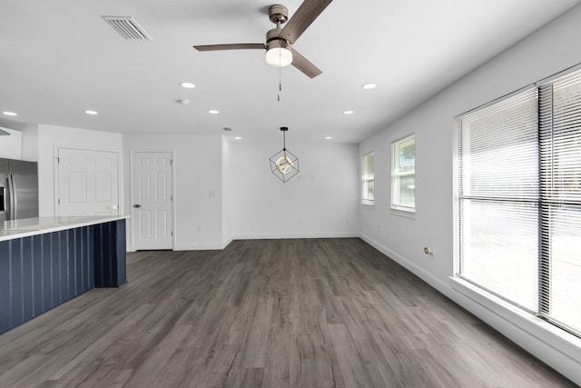 unfurnished living room with ceiling fan and dark hardwood / wood-style floors