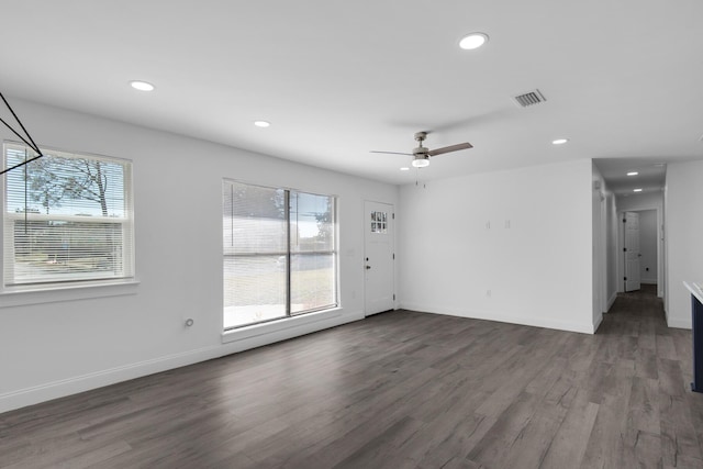 unfurnished room with dark hardwood / wood-style floors and ceiling fan