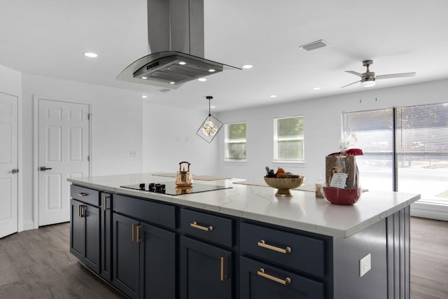 kitchen with island exhaust hood, dark hardwood / wood-style flooring, black electric cooktop, ceiling fan, and a kitchen island