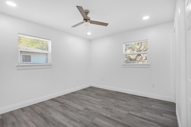 unfurnished room with ceiling fan and dark wood-type flooring