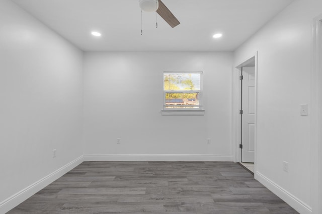 empty room with ceiling fan and wood-type flooring