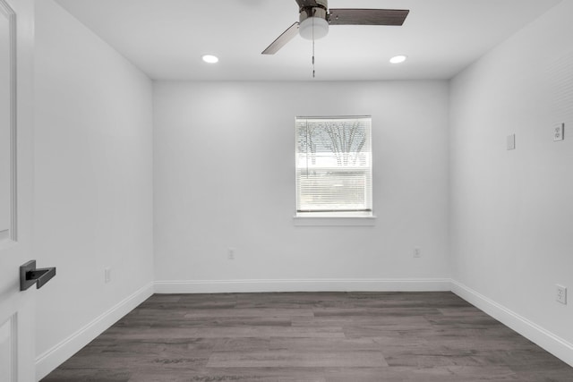 empty room with ceiling fan and dark wood-type flooring