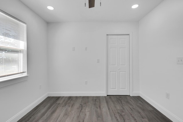 unfurnished room featuring ceiling fan and dark wood-type flooring