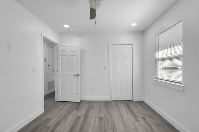 unfurnished bedroom featuring ceiling fan and light hardwood / wood-style floors