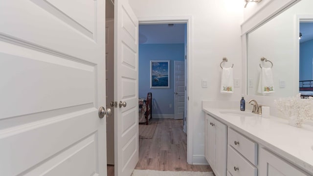 bathroom with wood-type flooring and oversized vanity