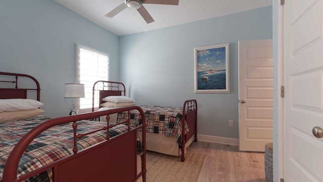 bedroom with light hardwood / wood-style floors and ceiling fan