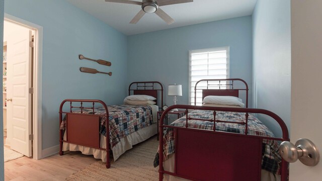 bedroom with connected bathroom, ceiling fan, and light wood-type flooring